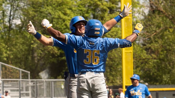 UCLA’s Dean West, left, celebrates his first inning home run with teammate Roman Martin at PK Park in Eugene.