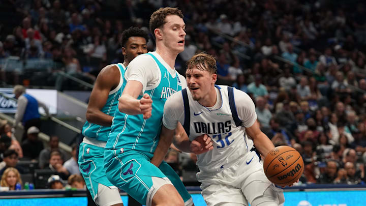 Oct 11, 2025; Dallas, Texas, USA; Dallas Mavericks forward Cooper Flagg (32) drives around Charlotte Hornets center Ryan Kalkbrenner (11) in the second half of a game at American Airlines Center. Mandatory Credit: Raymond Carlin III-Imagn Images