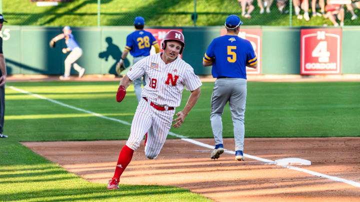 Garrett Anglim rounds third to score on Riley Silva’s triple.