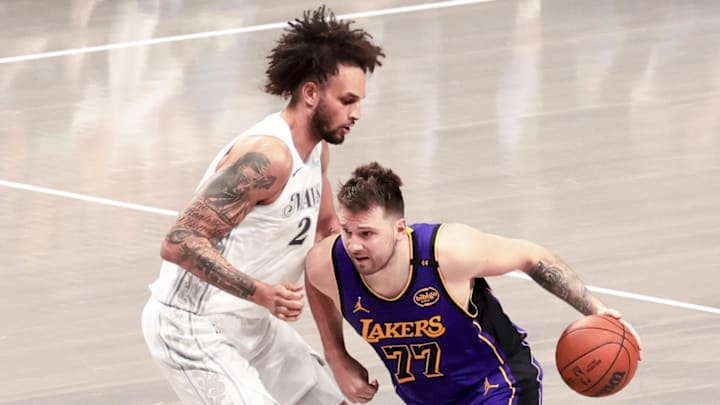 Apr 9, 2025; Dallas, Texas, USA;  Los Angeles Lakers guard Luka Doncic (77) dribbles as Dallas Mavericks center Dereck Lively II (2) defends during the second quarter at American Airlines Center. Mandatory Credit: Kevin Jairaj-Imagn Images