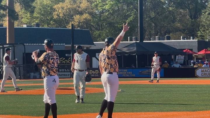 Matthew Russo salutes The Roost and 16oz. Lounge at Pete Taylor Park after an RBI single.