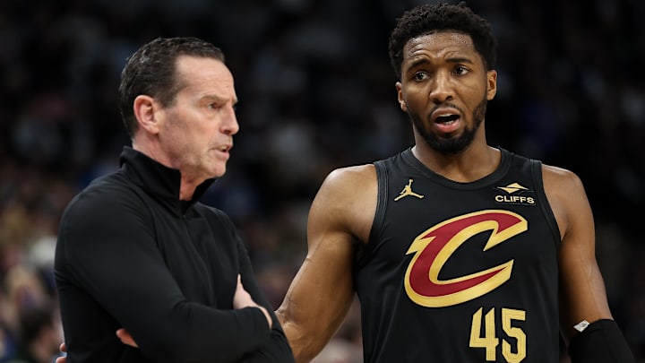 Jan 18, 2025; Minneapolis, Minnesota, USA; Cleveland Cavaliers guard Donovan Mitchell (45) talks with head coach Kenny Atkinson during the second quarter against the Minnesota Timberwolves at Target Center. Mandatory Credit: Matt Krohn-Imagn Images