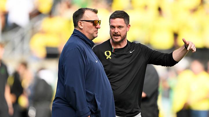 Oct 26, 2024; Eugene, Oregon, USA; Illinois Fighting Illini head coach Bret Bielema, left, and Oregon Ducks head coach Dan Lanning talk before a game at Autzen Stadium. Mandatory Credit: Troy Wayrynen-Imagn Images Oct 26, 2024; Eugene, Oregon, USA; Illinois Fighting Illini head coach Bret Bielema, left, and Oregon Ducks head coach Dan Lanning talk before a game at Autzen Stadium. Mandatory Credit: Troy Wayrynen-Imagn Images