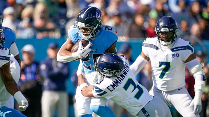 Tennessee Titans running back Tony Pollard (20) is tackled by Seattle Seahawks safety Nick Emmanwori (3) during the first quarter at Nissan Stadium in Nashville, Tenn., Sunday, Nov. 23, 2025.