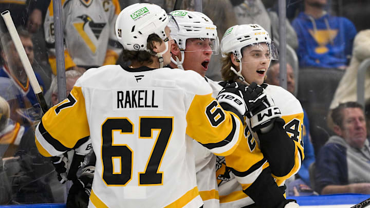 Apr 3, 2025; St. Louis, Missouri, USA;  Pittsburgh Penguins right wing Rutger McGroarty (2) is congratulated by right wing Rickard Rakell (67) and right wing Ville Koivunen (41) after scoring his first NHL goal to tie the game against the St. Louis Blues during the third period at Enterprise Center. Mandatory Credit: Jeff Curry-Imagn Images