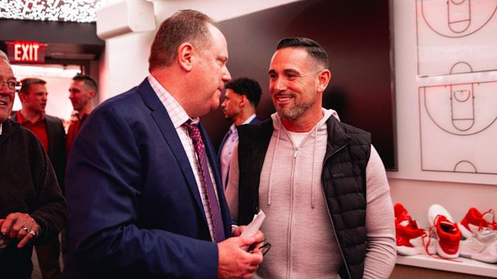 Wisconsin Badgers head coach Greg Gard speaks to Green Bay Packers coach Matt LaFleur in the locker room after the Badgers beat No.10 Michigan State, 92-71.