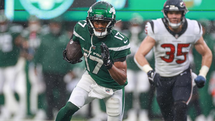 Dec 10, 2023; East Rutherford, New Jersey, USA; New York Jets wide receiver Garrett Wilson (17) gains yards after catch as Houston Texans linebacker Jake Hansen (35) pursues during the second half at MetLife Stadium. Mandatory Credit: Vincent Carchietta-Imagn Images