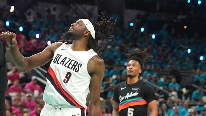 San Antonio Spurs forward Victor Wembanyama dunks ahead of Portland Trail Blazers forward Jerami Grant