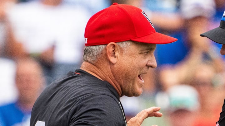Jun 15, 2024; Omaha, NE, USA; NC State Wolfpack head coach Elliott Avent talks with an official during the seventh inning against the Kentucky Wildcats at Charles Schwab Field Omaha. Mandatory Credit: Dylan Widger-Imagn Images
