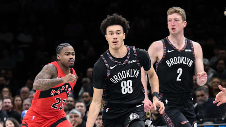 Dec 21, 2025; Brooklyn, New York, USA; Brooklyn Nets guard Nolan Traore (88) brings the ball up court while defended by Toronto Raptors guard/forward Gradey Dick (1) during the first half at Barclays Center. Mandatory Credit: John Jones-Imagn Images