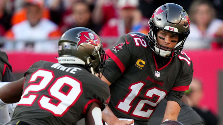 Tampa Bay Buccaneers quarterback Tom Brady hands the ball off to running back Rachaad White.