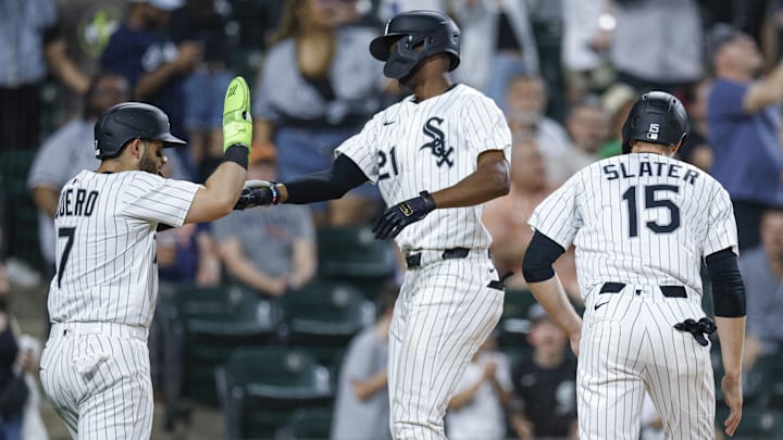 Chicago White Sox outfielder Michael A. Taylor (21) celebrates with catcher Edgar Quero (7) and outfielder Austin Slater (15) after hitting a three-run home run against the Detroit Tigers at Rate Field. Chicago White Sox outfielder Michael A. Taylor (21) celebrates with catcher Edgar Quero (7) and outfielder Austin Slater (15) after hitting a three-run home run against the Detroit Tigers at Rate Field.