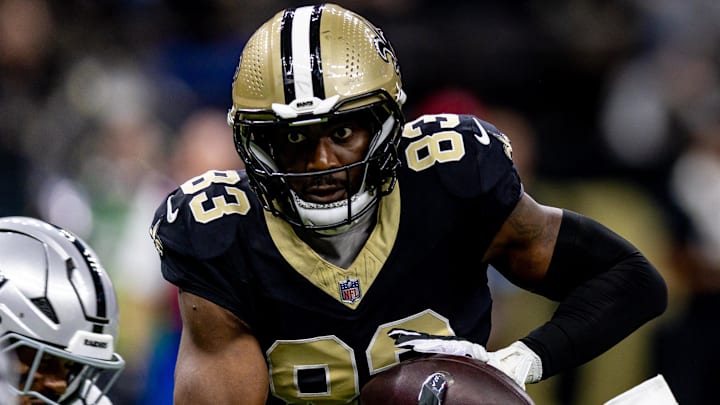 Dec 29, 2024; New Orleans, Louisiana, USA;  New Orleans Saints tight end Juwan Johnson (83) catches a pass against the Las Vegas Raiders during the first half at Caesars Superdome. Mandatory Credit: Stephen Lew-Imagn Images