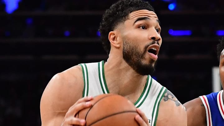 Apr 19, 2026; Boston, Massachusetts, USA; Boston Celtics forward Jayson Tatum (0) controls the ball ahead of Philadelphia 76ers forward Justin Edwards (11) in the second half during game one of the first round of the 2026 NBA Playoffs at TD Garden. Mandatory Credit: Bob DeChiara-Imagn Images