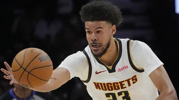 Apr 23, 2026; Minneapolis, Minnesota, USA; Denver Nuggets forward Cameron Johnson (23) goes after the ball against the Minnesota Timberwolves in the third quarter at Target Center. Mandatory Credit: Bruce Kluckhohn-Imagn Images