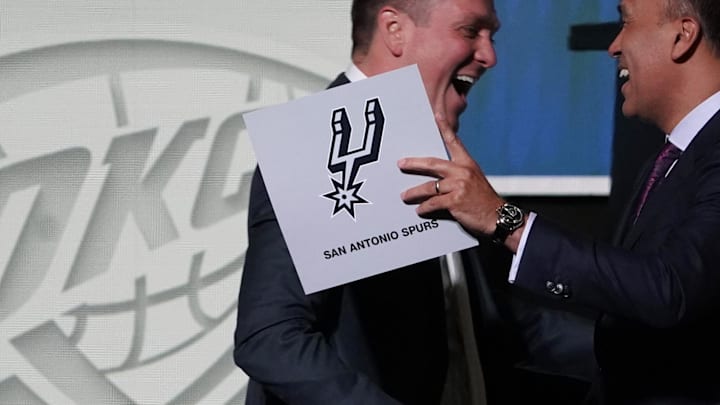 May 16, 2023; Chicago, IL, USA; NBA Deputy Commissioner Mark Tatum (right) congratulates San Antonio Spurs managing partner Peter J. Holt (left) on the first pick in the 2023 NBA Draft Lottery at McCormick Place West. Mandatory Credit: David Banks-Imagn Images