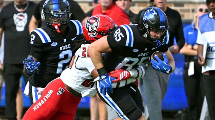 Sep 20, 2025; Durham, North Carolina, USA; Duke Blue Devils tight end Jeremiah Hasley (85) is tackled by North Carolina State Wolfpack defensive back Asaad Brown Jr. (26) during the first quarter at Wallace Wade Stadium. Mandatory Credit: Zachary Taft-Imagn Images Sep 20, 2025; Durham, North Carolina, USA; Duke Blue Devils tight end Jeremiah Hasley (85) is tackled by North Carolina State Wolfpack defensive back Asaad Brown Jr. (26) during the first quarter at Wallace Wade Stadium. Mandatory Credit: Zachary Taft-Imagn Images