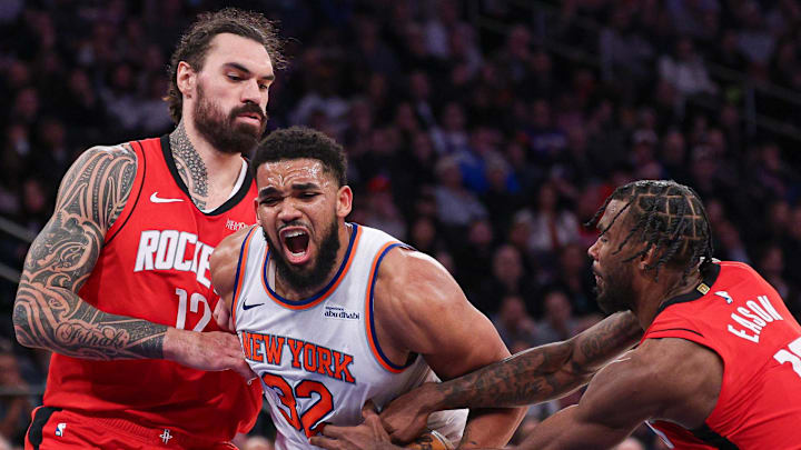 Feb 3, 2025; New York, New York, USA; New York Knicks center Karl-Anthony Towns (32) goes to the basket as Houston Rockets forward Tari Eason (17) and center Steven Adams (12) defend during the second half at Madison Square Garden. Mandatory Credit: Vincent Carchietta-Imagn Images