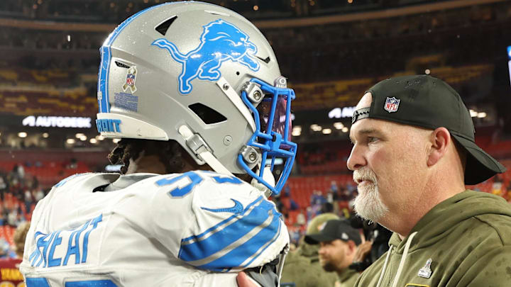 Washington Commanders head coach Dan Quinn (R) congratulates Detroit Lions defensive end Tyrus Wheat (99) 