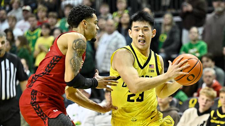 Feb 25, 2026; Eugene, Oregon, USA; Oregon Ducks guard Wei Lin (23) drives to the basket against Wisconsin Badgers guard Nick Boyd (2) during the first half at Matthew Knight Arena. Mandatory Credit: Craig Strobeck-Imagn Images Feb 25, 2026; Eugene, Oregon, USA; Oregon Ducks guard Wei Lin (23) drives to the basket against Wisconsin Badgers guard Nick Boyd (2) during the first half at Matthew Knight Arena. Mandatory Credit: Craig Strobeck-Imagn Images