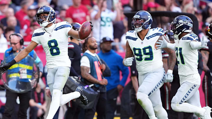 Dec 8, 2024; Glendale, Arizona, USA; Seattle Seahawks cornerback Coby Bryant (8) celebrates an interception against the Arizona Cardinals during the first half at State Farm Stadium.