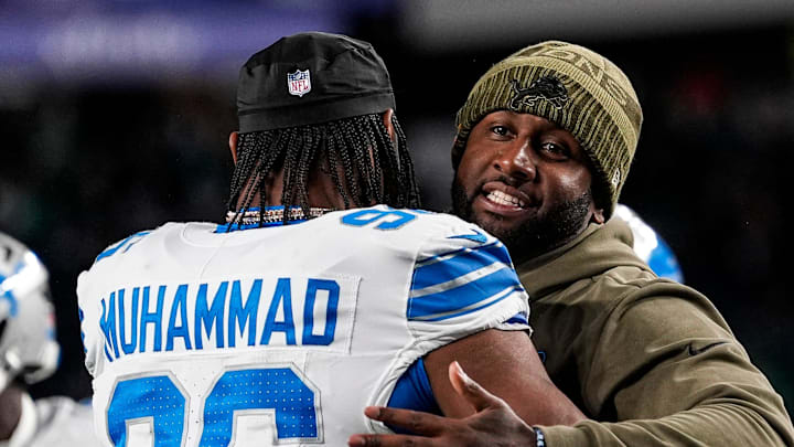 Detroit Lions defensive coordinator Kelvin Sheppard hugs linebacker Al-Quadin Muhammad (96)