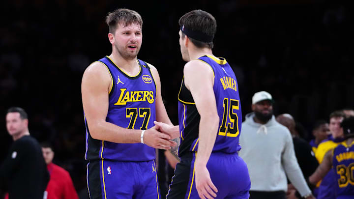 Mar 17, 2025; Los Angeles, California, USA; Los Angeles Lakers guard Luka Doncic (77) and guard Austin Reaves (15) react against the San Antonio Spurs in the first half at Crypto.com Arena.