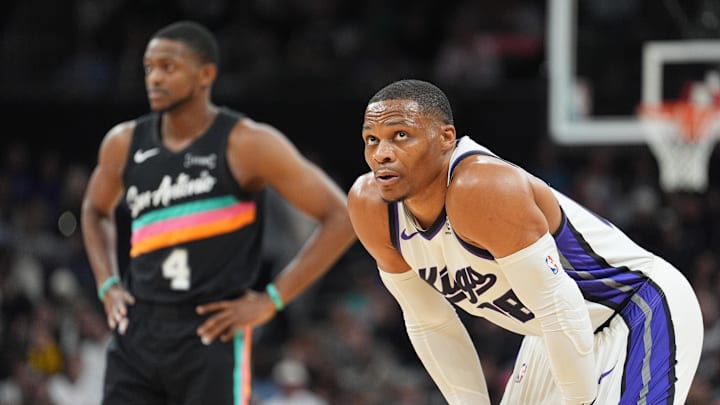 Feb 21, 2026; Austin, Texas, USA;  Sacramento Kings guard Russell Westbrook (18) looks up in front of San Antonio Spurs guard De'Aaron Fox (4) in the first half at Moody Center.