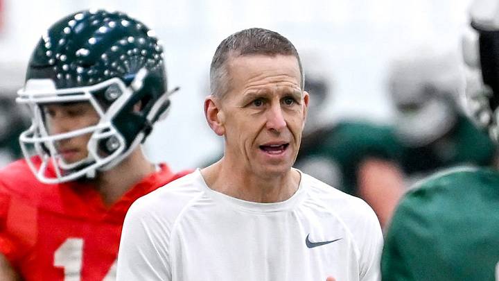Michigan State's offensive coordinator Jay Johnson, left, talks with Jayden Reed during practice on Tuesday, March 29, 2022, at the indoor football facility in East Lansing.