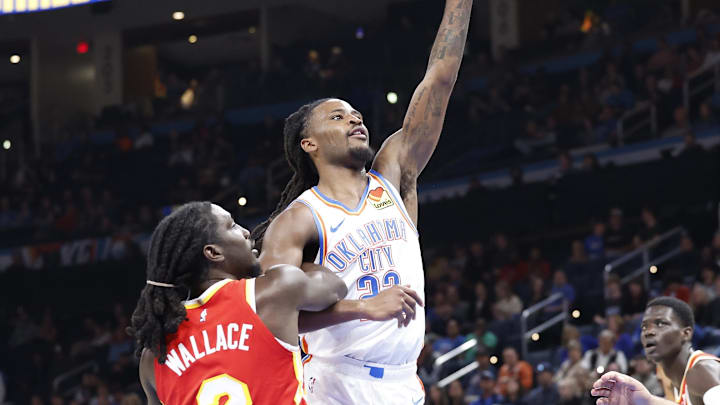 Oct 17, 2024; Oklahoma City, Oklahoma, USA; Oklahoma City Thunder guard Cason Wallace (22) shoots over Atlanta Hawks guard Keaton Wallace (2) during the second half at Paycom Center. Mandatory Credit: Alonzo Adams-Imagn Images