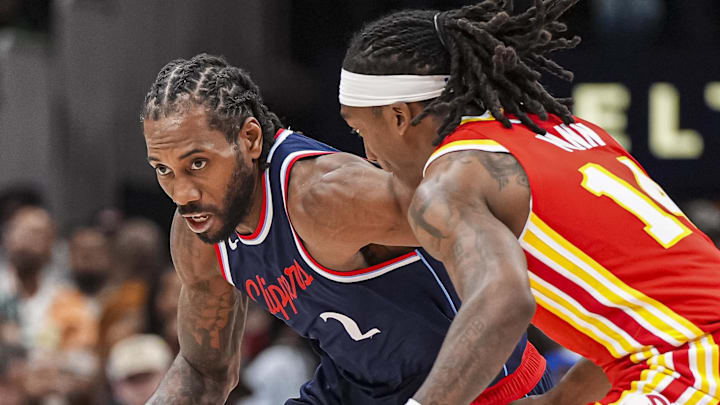 Mar 14, 2025; Atlanta, Georgia, USA; LA Clippers forward Kawhi Leonard (2) dribbles against Atlanta Hawks guard Terance Mann (14) during the second half at State Farm Arena. Mandatory Credit: Dale Zanine-Imagn Images