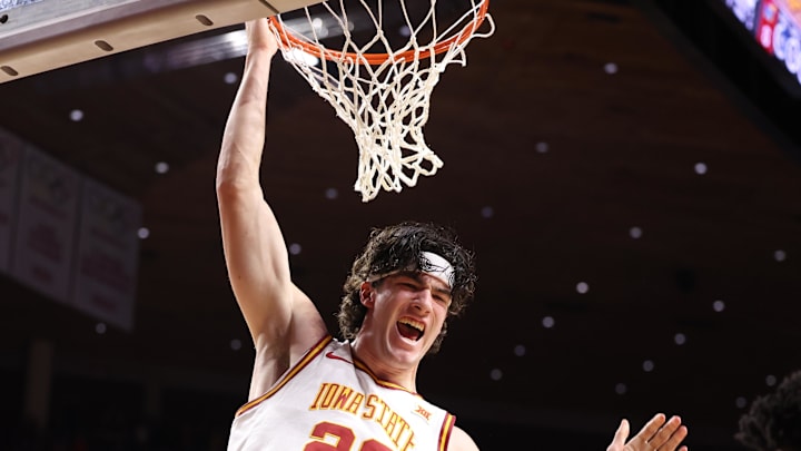 Feb 14, 2026; Ames, Iowa, USA; Iowa State Cyclones forward Blake Buchanan (23) finishes a dunk against the Kansas Jayhawks during the first half at James H. Hilton Coliseum. 