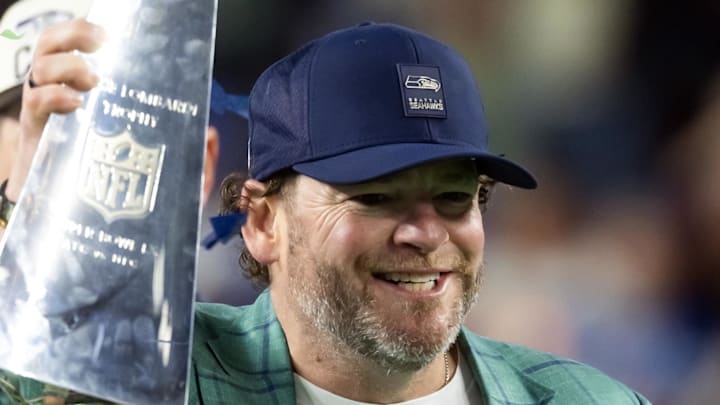 Seattle Seahawks general manager John Schneider celebrates with the Vince Lombardi trophy.