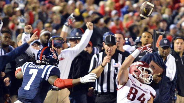 Arkansas Razorbacks tight end Hunter Henry (84) laterals the ball as he is tackled by Mississippi Rebels defensive back Tony Bridges (1) during overtime at Vaught-Hemingway Stadium. Arkansas won 53-52.  