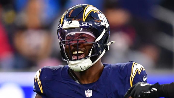 Dec 27, 2025; Inglewood, California, USA;  Los Angeles Chargers linebacker Odafe Oweh (98) and linebacker Daiyan Henley (0) react after a defensive play against the Houston Texans during the second half at SoFi Stadium. Mandatory Credit: Gary A. Vasquez-Imagn Images