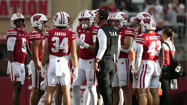 Sep 6, 2025; Madison, Wisconsin, USA;  Wisconsin Badgers head coach Luke Fickell talks with his team during a timeout against the Middle Tennessee Blue Raiders during the second half at Camp Randall Stadium. Mandatory Credit: Kayla Wolf-Imagn Images