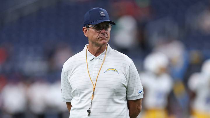 Aug 13, 2026; Houston, Texas, USA;  Los Angeles Chargers head coach Jim Harbaugh walks on the field during warm ups before the game against the Houston Texans at Reliant Stadium. Mandatory Credit: Troy Taormina-Imagn Images