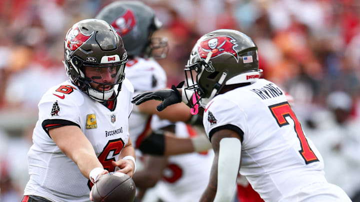 Nov 10, 2024; Tampa, Florida, USA; Tampa Bay Buccaneers quarterback Baker Mayfield (6) hands off to running back Bucky Irving (7) against the San Francisco 49ers in the second quarter at Raymond James Stadium. Mandatory Credit: Nathan Ray Seebeck-Imagn Images