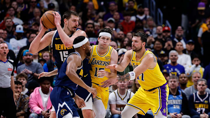 Mar 5, 2026; Denver, Colorado, USA; Denver Nuggets center Nikola Jokic (15) controls the ball as Los Angeles Lakers guard Austin Reaves (15) and guard Luka Doncic (77) defend against guard Bruce Brown (11) in the fourth quarter at Ball Arena. Mandatory Credit: Isaiah J. Downing-Imagn Images Mar 5, 2026; Denver, Colorado, USA; Denver Nuggets center Nikola Jokic (15) controls the ball as Los Angeles Lakers guard Austin Reaves (15) and guard Luka Doncic (77) defend against guard Bruce Brown (11) in the fourth quarter at Ball Arena. Mandatory Credit: Isaiah J. Downing-Imagn Images