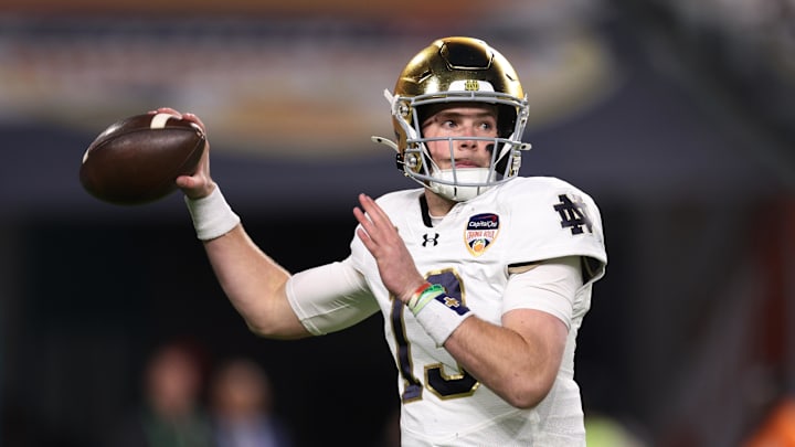 Notre Dame quarterback Riley Leonard (13) drops back to pass against the Penn State Nittany Lions  in the Orange Bowl. 
