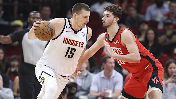 Apr 4, 2023; Houston, Texas, USA; Denver Nuggets center Nikola Jokic (15) controls the ball as Houston Rockets center Alperen Sengun (28) defends during the first quarter at Toyota Center. Mandatory Credit: Troy Taormina-Imagn Images