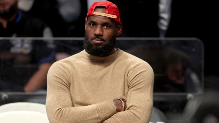 Mar 10, 2025; Brooklyn, New York, USA; Los Angeles Lakers forward LeBron James (23) watches from the bench during the fourth quarter against the Brooklyn Nets at Barclays Center. Mandatory Credit: Brad Penner-Imagn Images