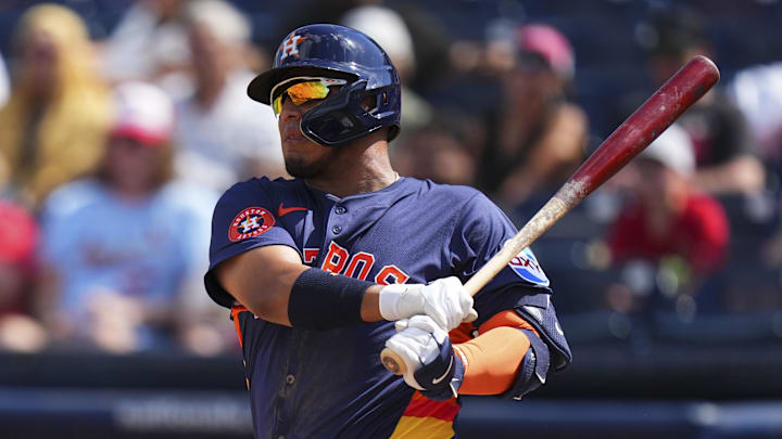 Mar 5, 2025; West Palm Beach, Florida, USA; Houston Astros third base Isaac Paredes (15) hits a double against the St. Louis Cardinals during the fourth inning at CACTI Park of the Palm Beaches.