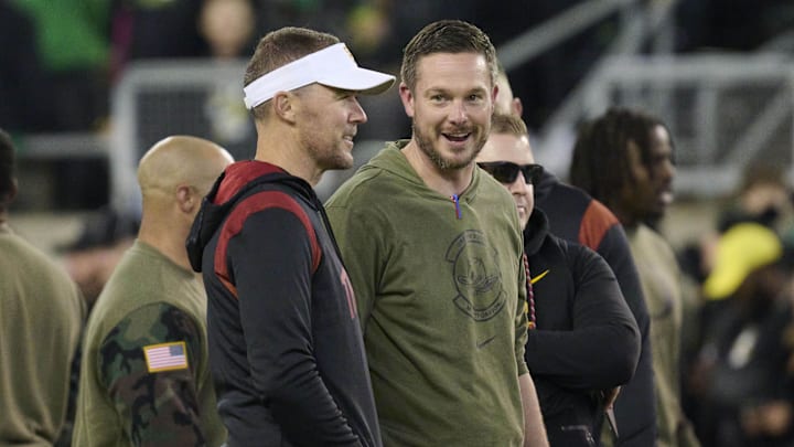 Nov 11, 2023; Eugene, Oregon, USA; USC Trojans head coach Lincoln Riley, left, and Oregon Ducks head coach Dan Lanning talk before a game at Autzen Stadium.