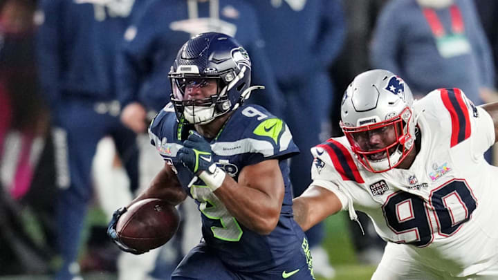 Feb 8, 2026; Santa Clara, CA, USA; Seattle Seahawks running back Kenneth Walker III (9) runs the ball as New England Patriots defensive tackle Christian Barmore (90) defends during the third quarter in Super Bowl LX at Levi's Stadium. Mandatory Credit: Cary Edmondson-Imagn Images