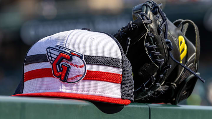 Jul 8, 2024; Detroit, Michigan, USA; A Cleveland Guardians baseball cap and glove sit on the dugout rail before the game against the Detroit Tigers at Comerica Park. Mandatory Credit: David Reginek-Imagn Images Jul 8, 2024; Detroit, Michigan, USA; A Cleveland Guardians baseball cap and glove sit on the dugout rail before the game against the Detroit Tigers at Comerica Park. Mandatory Credit: David Reginek-Imagn Images