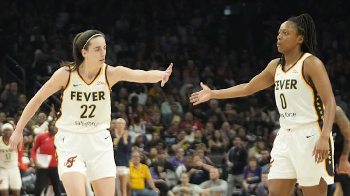 Jun 30, 2024; Phoenix, Ariz., U.S.; Indiana Fever guard Caitlin Clark (22) slaps hands with guard Kelsey Mitchell (0) during the third quarter against the Phoenix Mercury at Footprint Center. Mandatory Credit: Michael Chow-Arizona Republic Jun 30, 2024; Phoenix, Ariz., U.S.; Indiana Fever guard Caitlin Clark (22) slaps hands with guard Kelsey Mitchell (0) during the third quarter against the Phoenix Mercury at Footprint Center. Mandatory Credit: Michael Chow-Arizona Republic