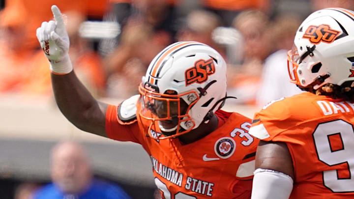 Oklahoma State's Collin Oliver (30) and Iman Oates (99) celebrate a play in the second half of the college football game between the Oklahoma State Cowboys and South Dakota State Jackrabbits at Boone Pickens Stadium in Stillwater, Okla., Saturday, Aug., 31, 2024.