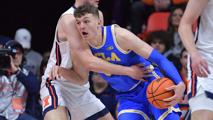 Feb 11, 2025; Champaign, Illinois, USA;  UCLA Bruins forward Tyler Bilodeau (34) drives to the basket as Illinois Fighting Illini center Tomislav Ivisic (13) defends during the first half at State Farm Center. Mandatory Credit: Ron Johnson-Imagn Images