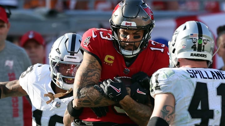 Dec 8, 2024; Tampa, Florida, USA; Tampa Bay Buccaneers wide receiver Mike Evans (13) runs with the ball as Las Vegas Raiders cornerback Jack Jones (18) and linebacker Robert Spillane (41) defend during the second half at Raymond James Stadium. Mandatory Credit: Kim Klement Neitzel-Imagn Images Dec 8, 2024; Tampa, Florida, USA; Tampa Bay Buccaneers wide receiver Mike Evans (13) runs with the ball as Las Vegas Raiders cornerback Jack Jones (18) and linebacker Robert Spillane (41) defend during the second half at Raymond James Stadium. Mandatory Credit: Kim Klement Neitzel-Imagn Images